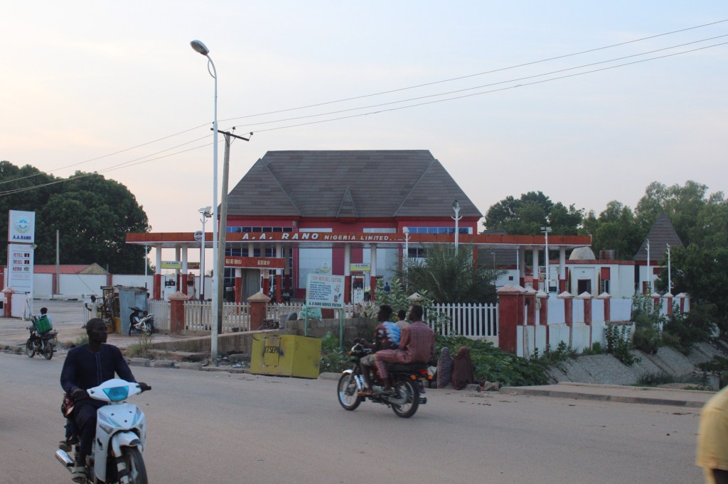 Motorcyclists passing the A A Rano filling station in Katsina, Nigeria.