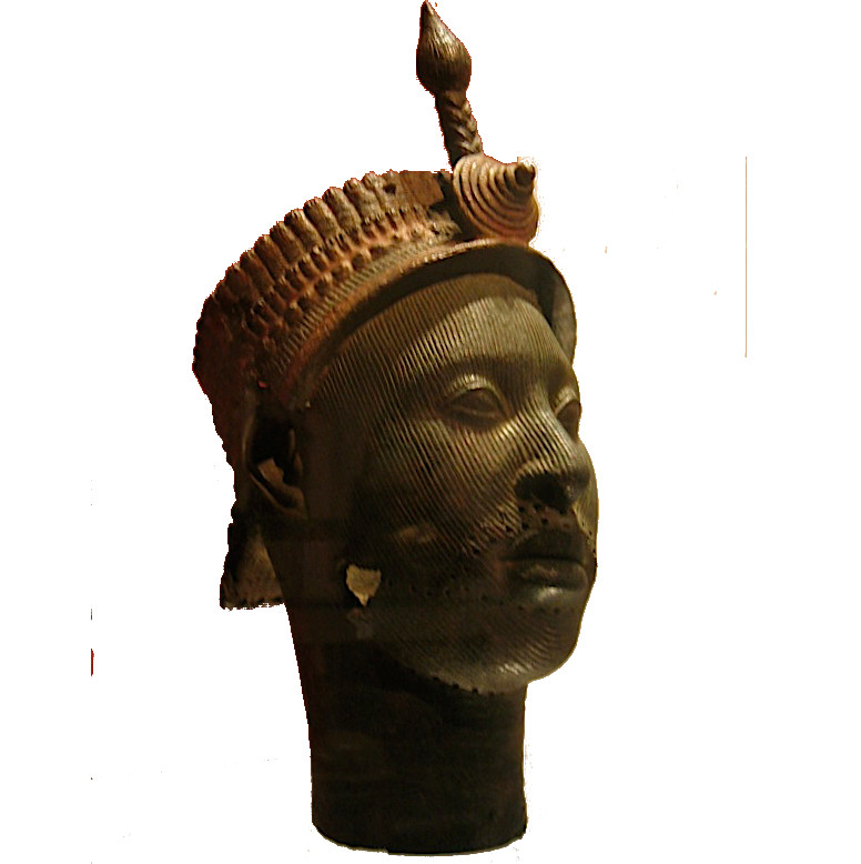 Brass Ife head with finely incised facial lines and an elaborate crown, photographed at the British Museum.
